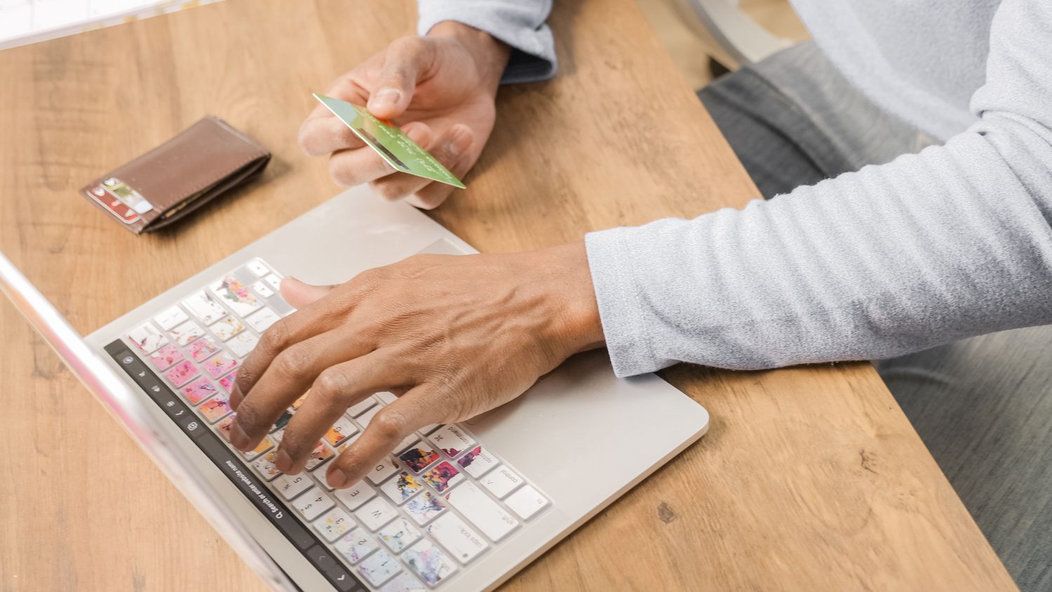 A customer entering payment information on a laptop