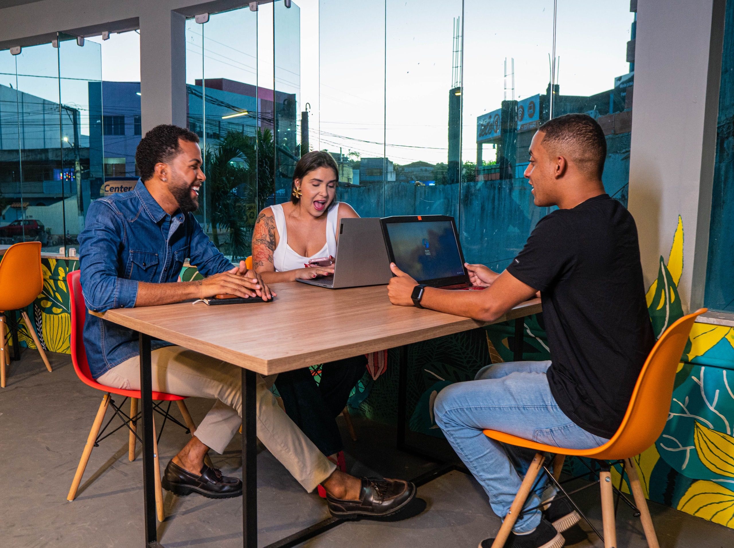 A collaborative studio conversation around a laptop